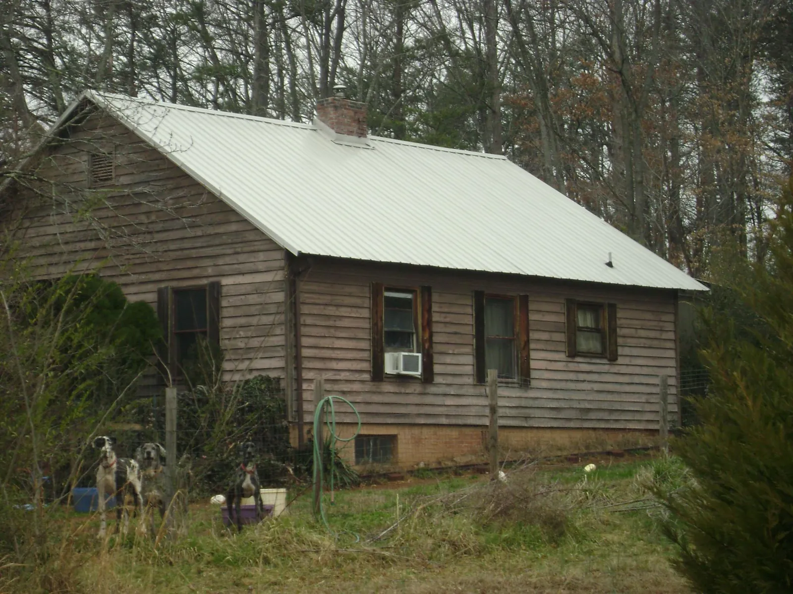 White metal roof on an old wood sided farmhouse in New London